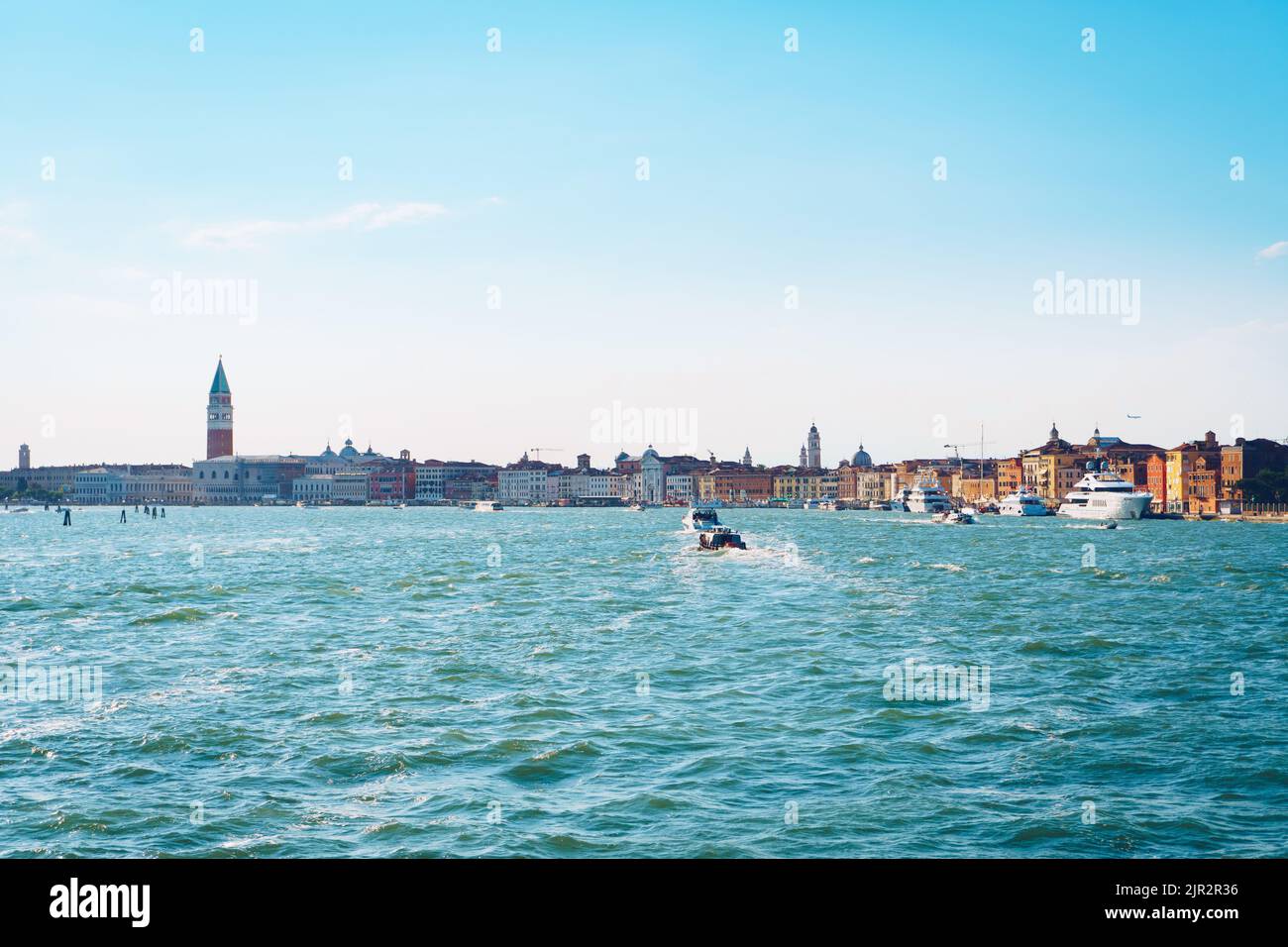 Venice in Italy in summer from the Ferry Boat on the sea. Famous touristic destination in Europe. Stock Photo