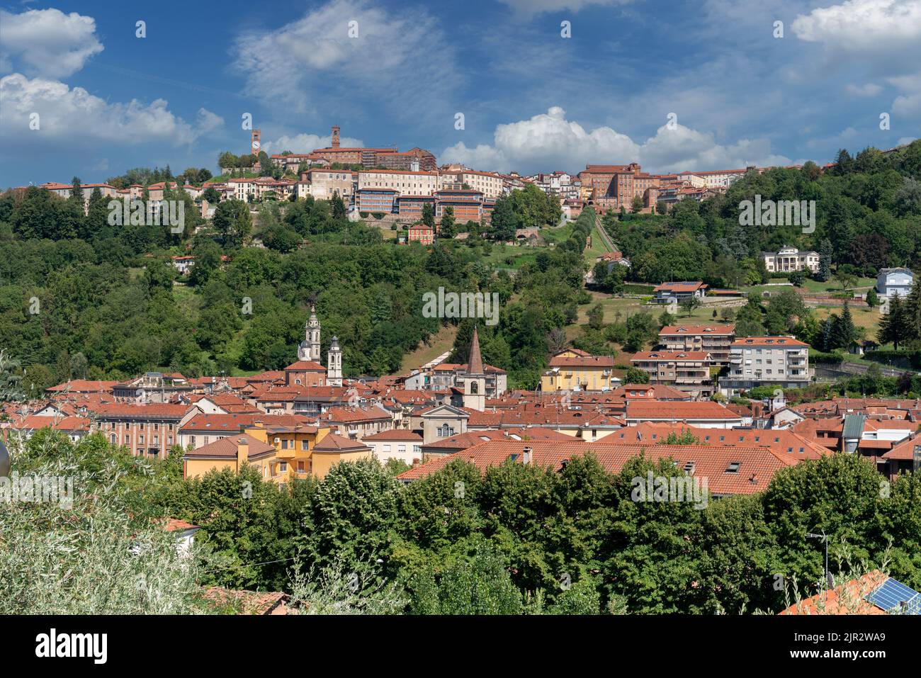 Mondovì, Cuneo, Italy. cityscape with below the Breo district and on the Mondovì hill Piazza with the clock tower and green parks with blue sky with w Stock Photo