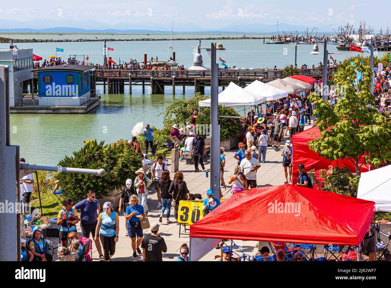Crowded waterfront at the 2022 Steveston Dragon Boat Festival in British Columbia Canada Stock Crowded waterfront at the 2022 Steveston Dragon Boat Festival in British Columbia Canada Stock