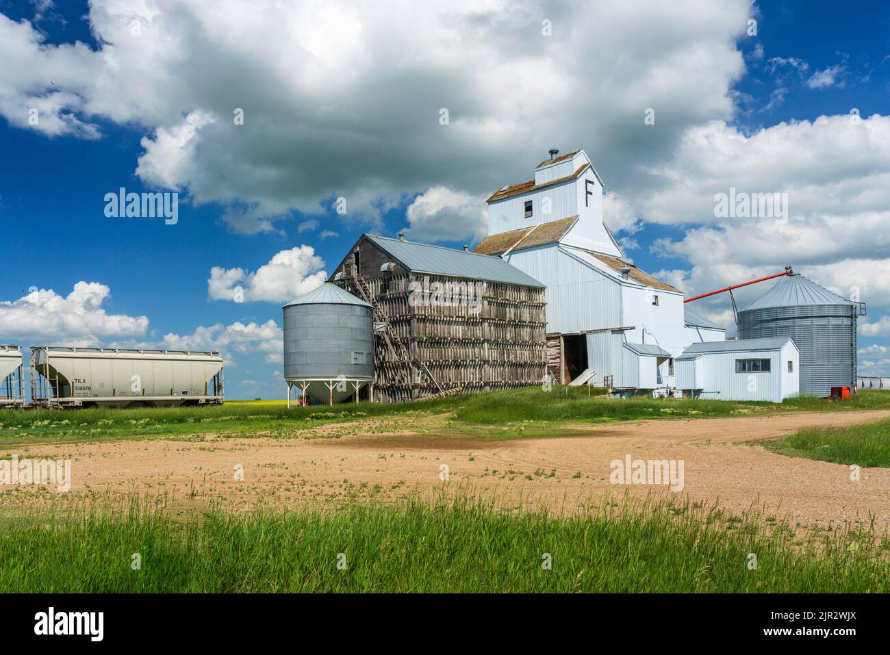 The grain storage elevator and train cars at Bromhead, Saskatchewan, Canada. Stock Photo