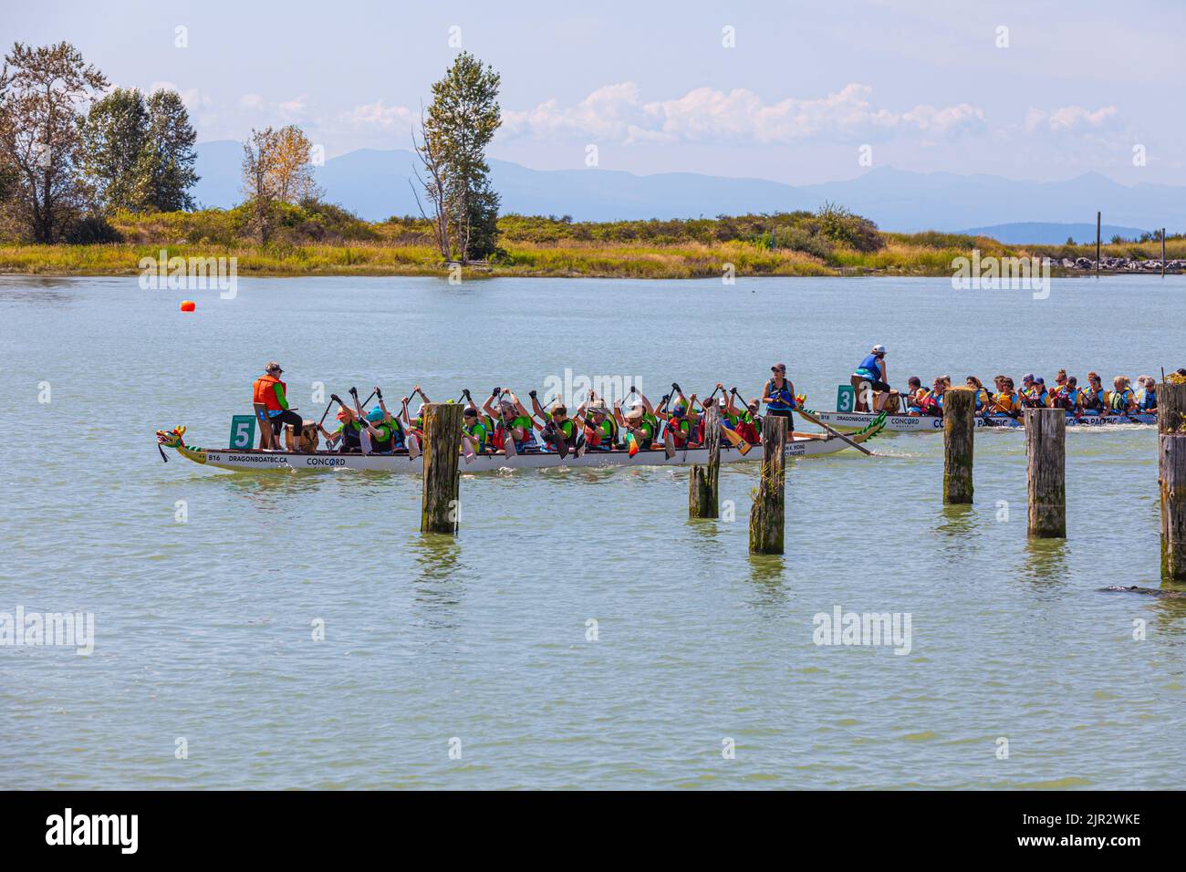 Dragon Boat crews making their way to the starting line at the 2022 Steveston Festival in British Columbia Canada Stock Photo