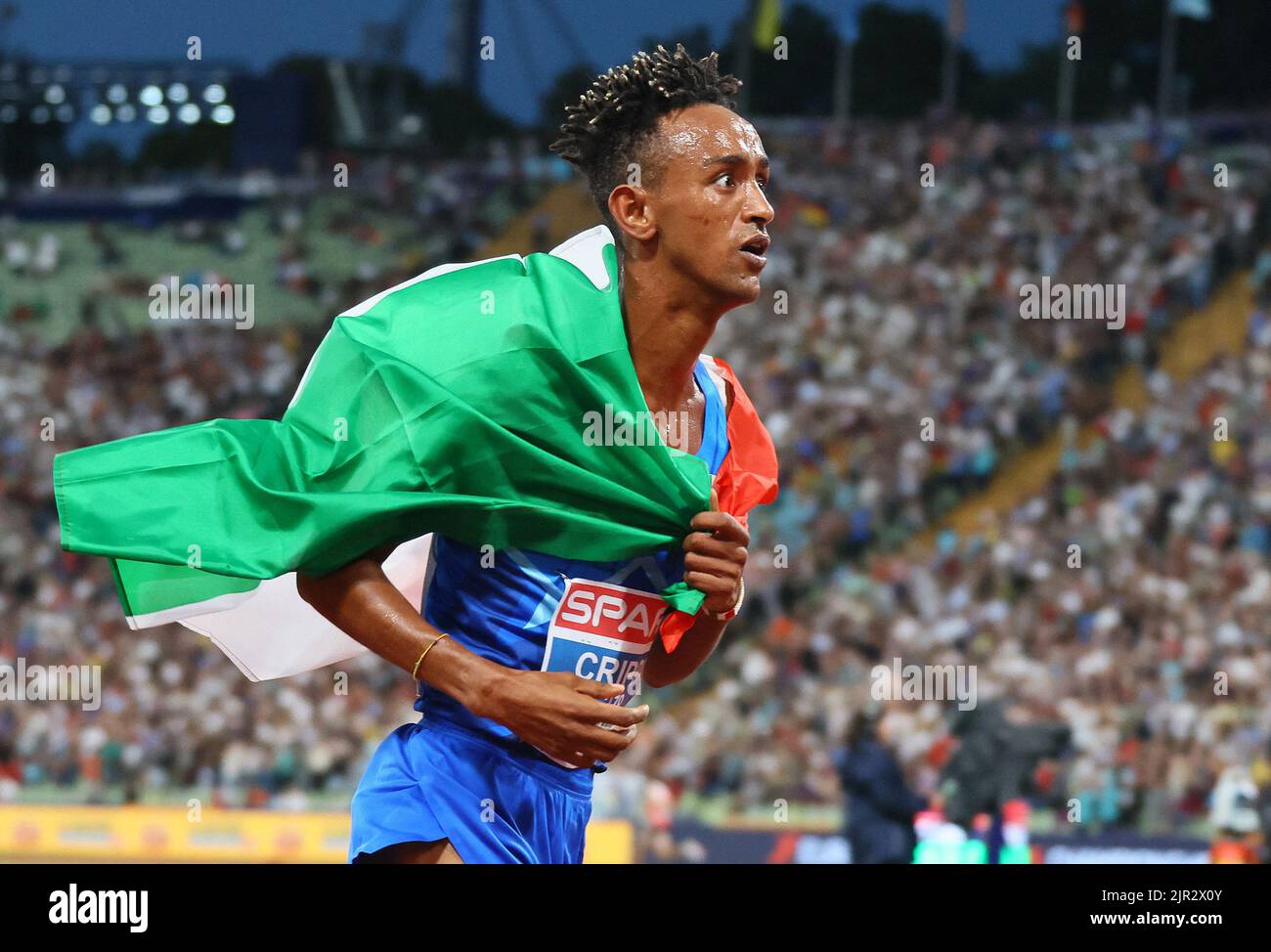 2022 European Championships - Athletics - Olympiastadion, Munich, Germany - August 21, 2022 Italy's Yemaneberhan Crippa celebrates after winning gold in the men's 10,000m final REUTERS/Wolfgang Rattay Stock Photo