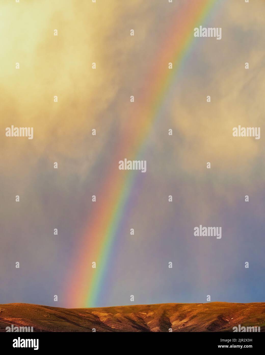 Rainbow over hills Stock Photo