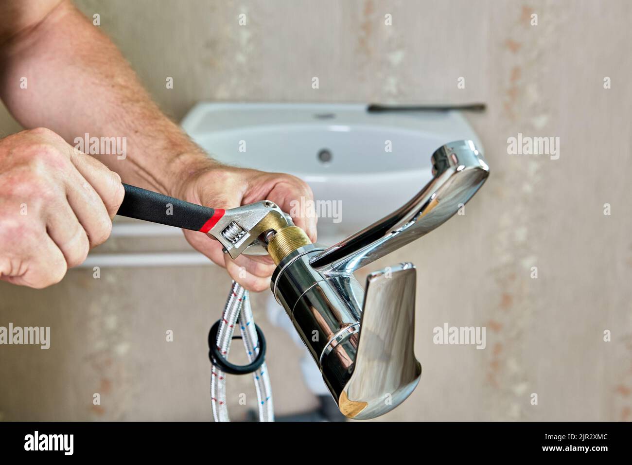 Repair work in bathroom, plumber installing new tap in home water