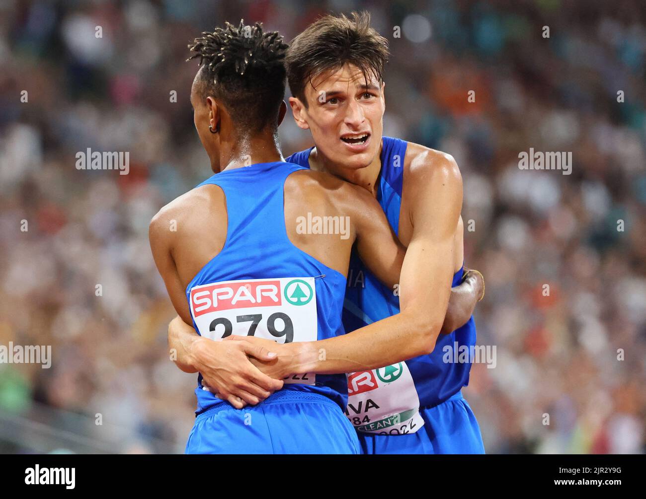 2022 European Championships - Athletics - Olympiastadion, Munich, Germany - August 21, 2022 Italy's Yemaneberhan Crippa reacts after finishing fifth in the men's 10,000m final with gold medallist Italy's Yemaneberhan Crippa REUTERS/Wolfgang Rattay Stock Photo