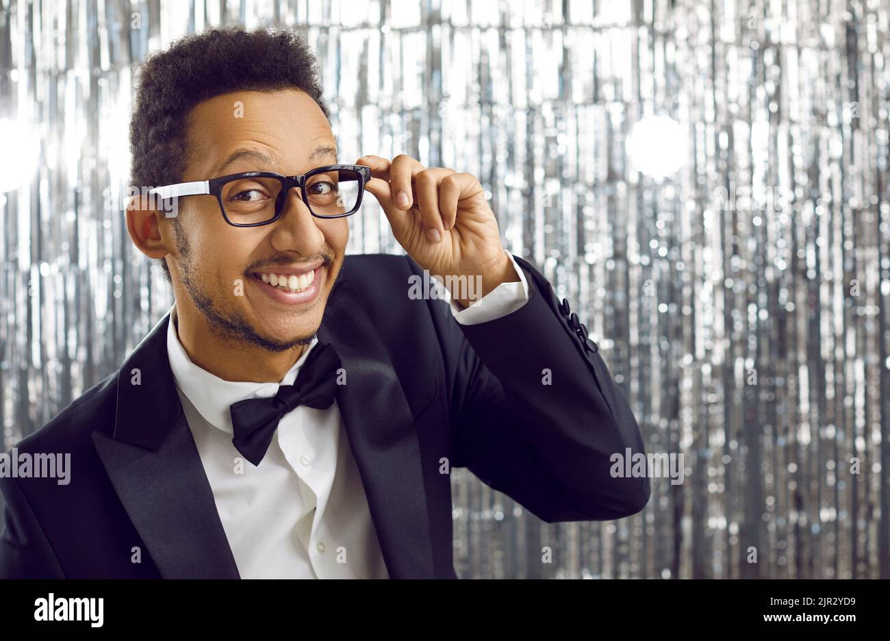 Happy handsome young black man in stylish suit and glasses looking at camera and smiling Stock Photo