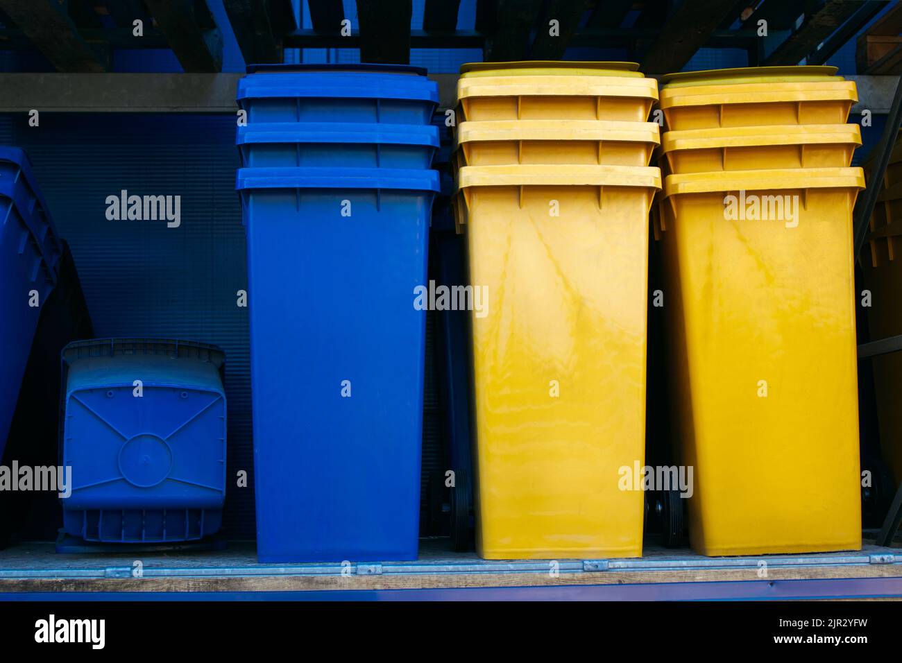 Paper and plastic recycle bins, yellow and blue Stock Photo Alamy