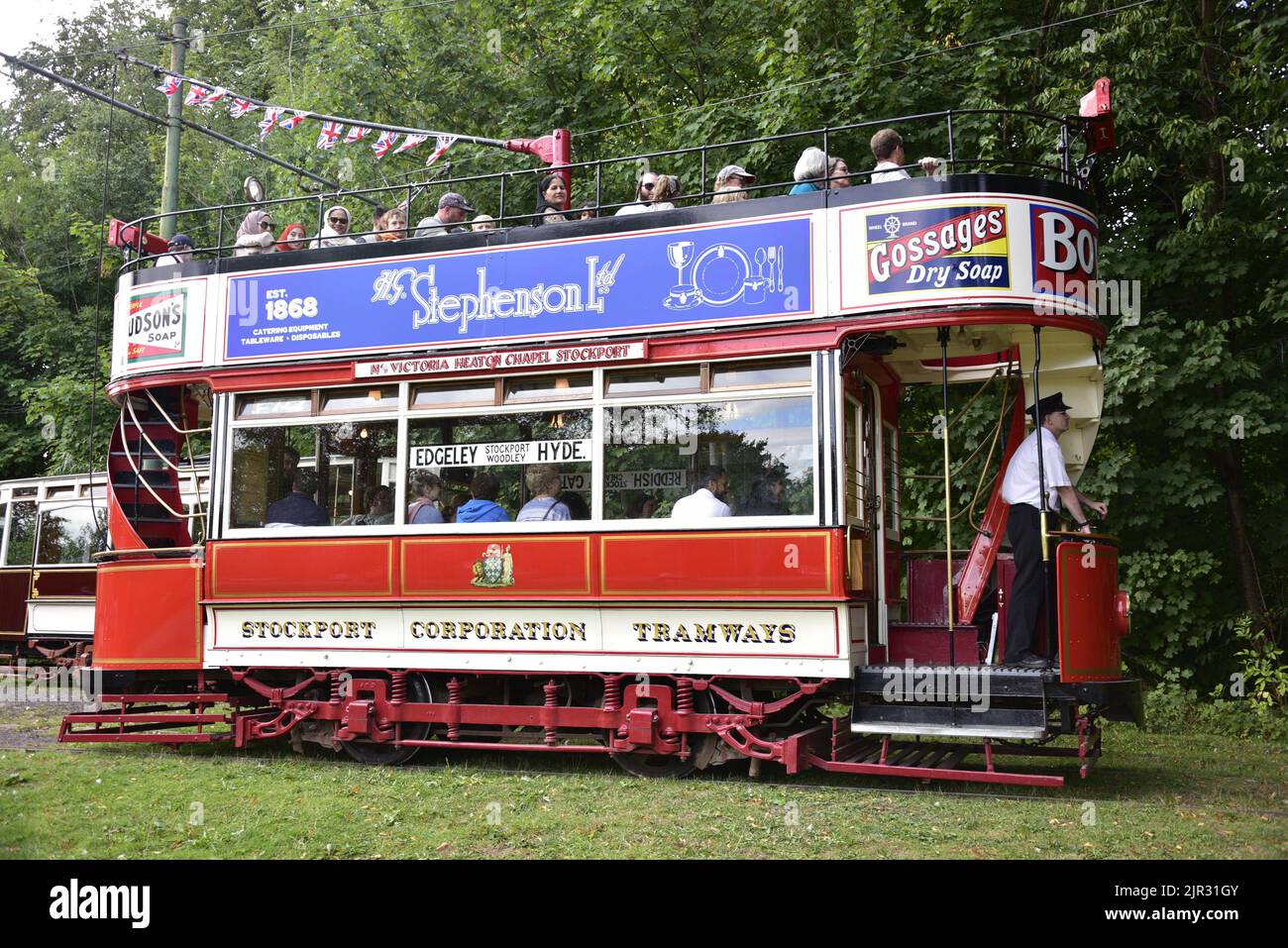 Manchester, UK. 21st August, 2022. Passengers enjoy a ride on Stockport 5, a four wheel open top Stockport tram with reverse staircases. Antique and vintage trams run in Heaton Park, Manchester, UK. Heaton Park Tramway is jointly run by the Manchester Transport Museum Society, who own a number of vintage trams, and Manchester City Council. Credit: Terry Waller/Alamy Live News Stock Photo