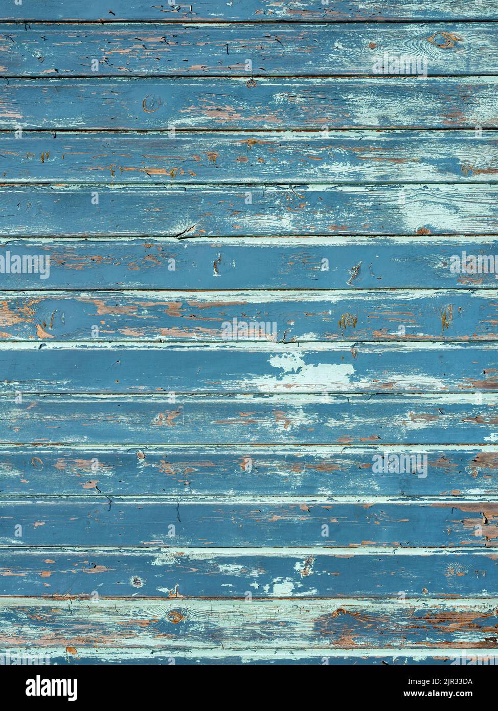 vertical background consisting of wheathered old grungy blue planks with peeling paint Stock Photo
