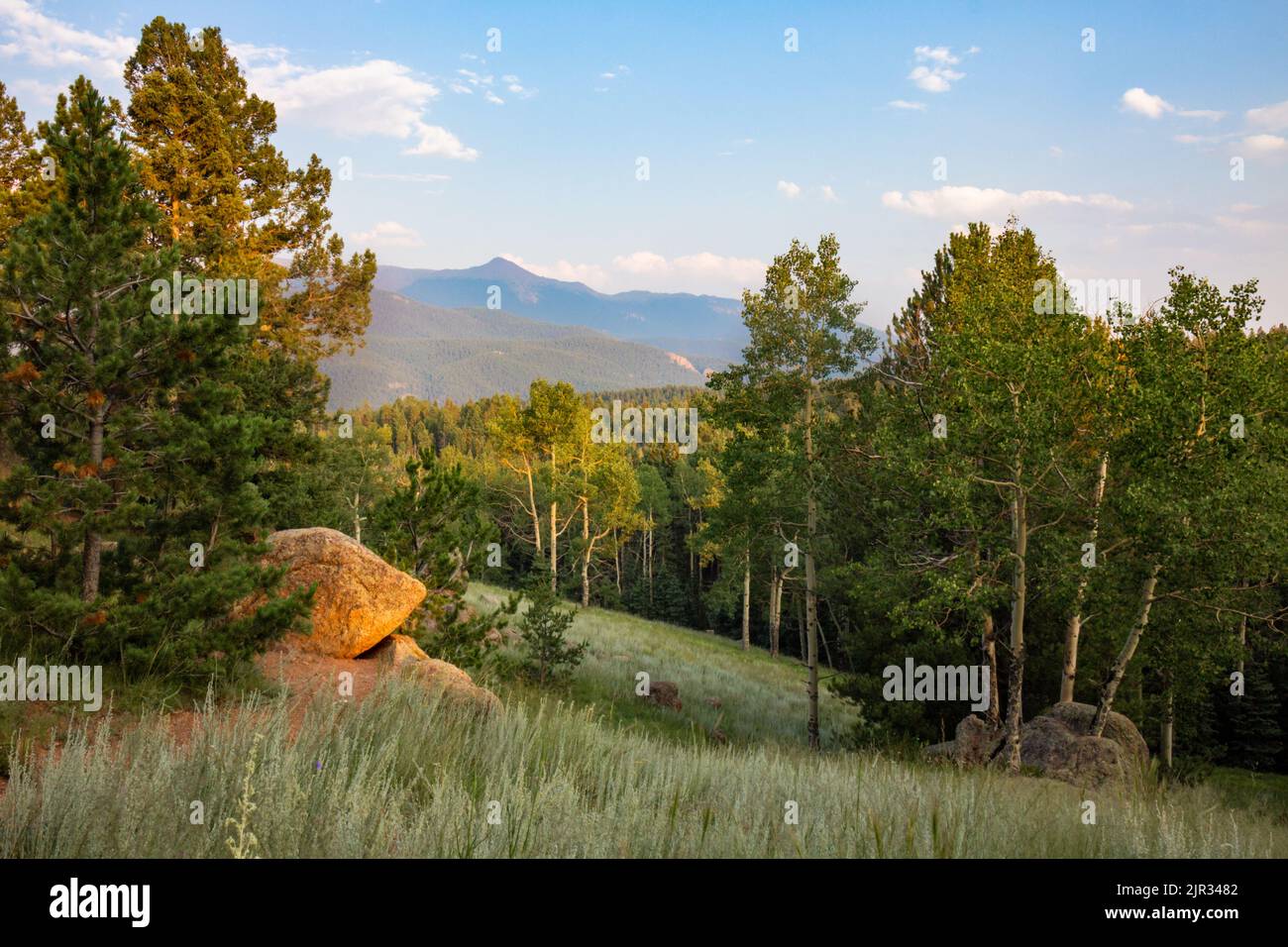 The warm light of a late summer evening covers a Rocky Mountain landscape full of angles in light and shadow Stock Photo
