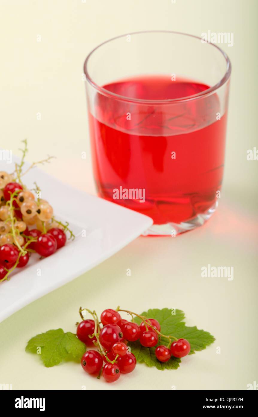 Fresh red and white currant berries and a cup of fruit juice Stock Photo