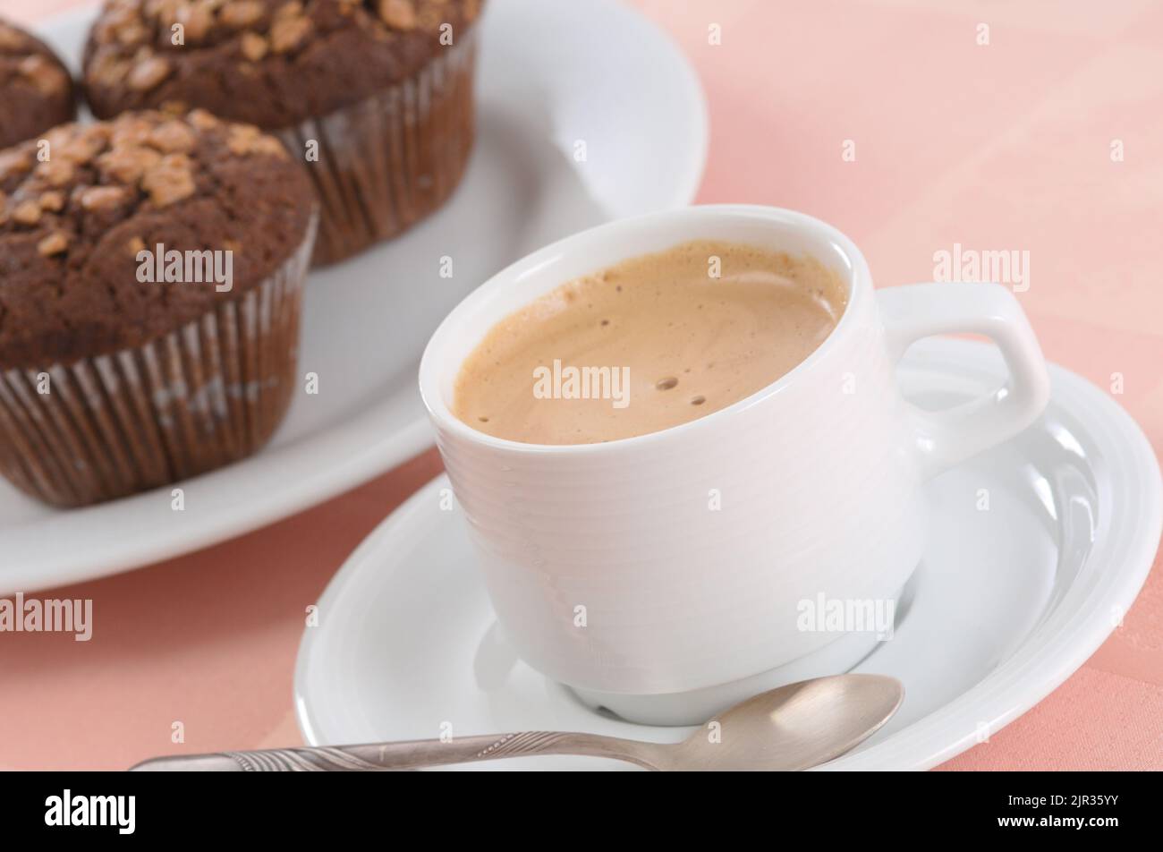 Cup of black coffee and chocolate chip muffins Stock Photo