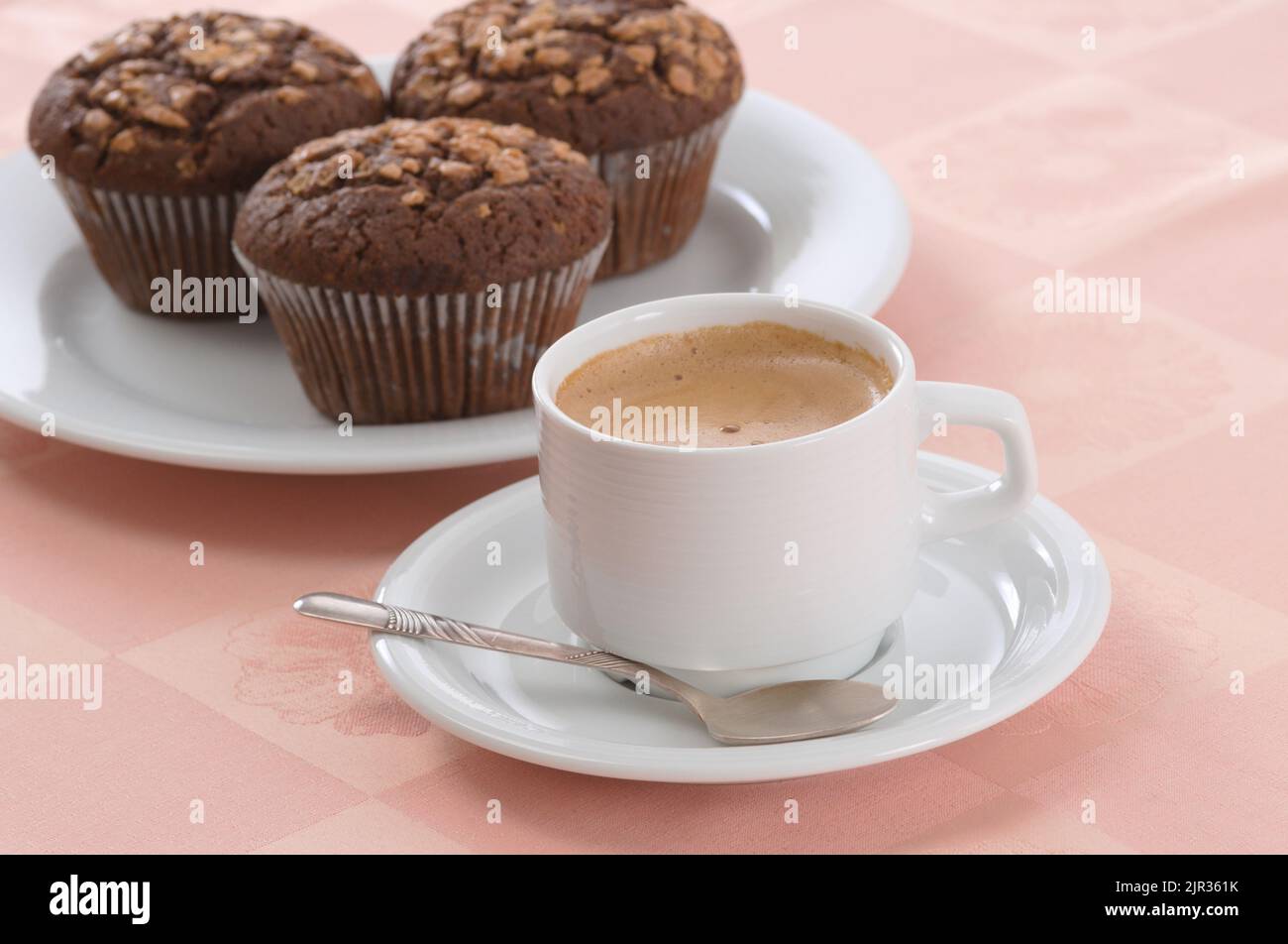 Cup of black coffee and chocolate chip muffins Stock Photo