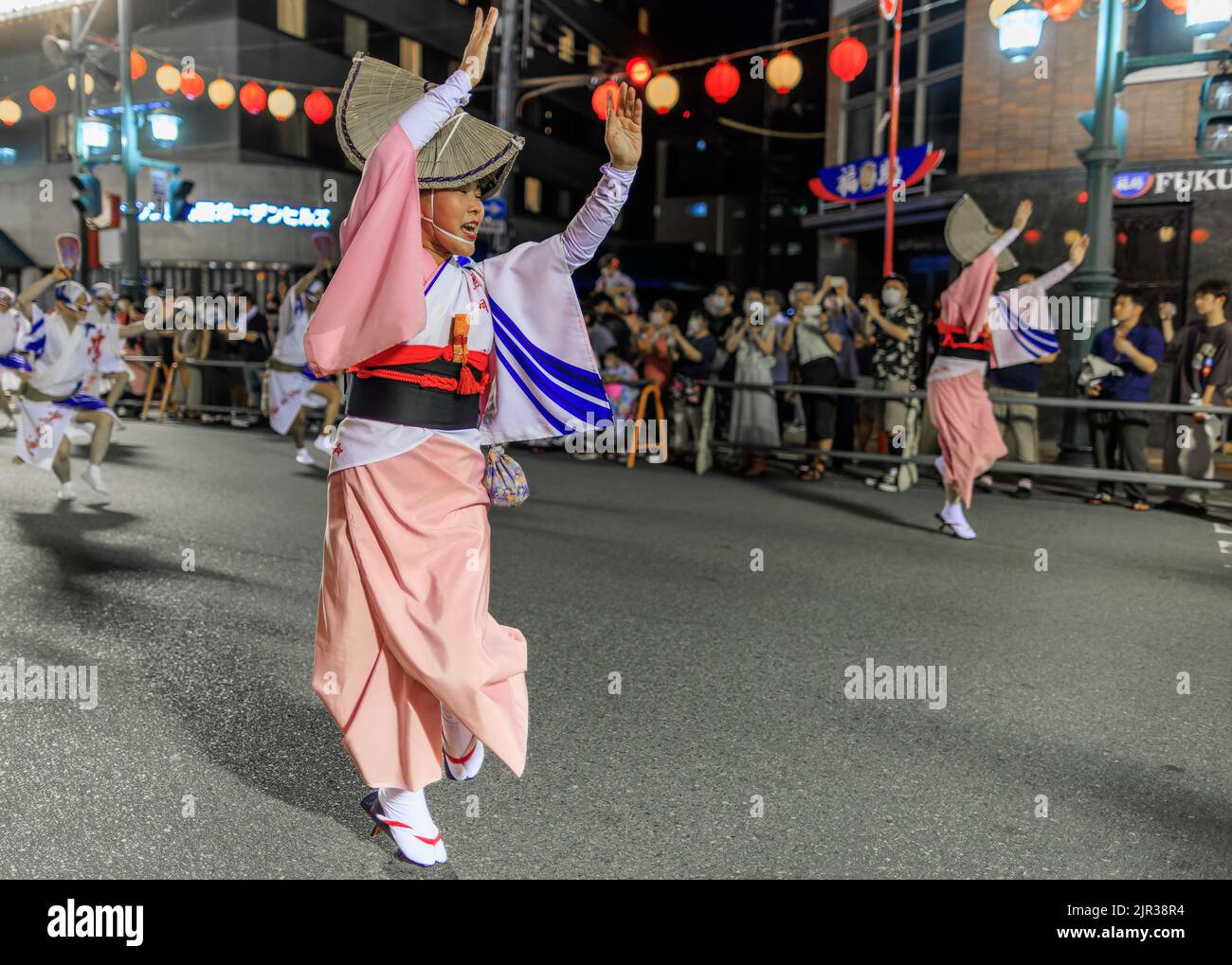 Tokushima, Japan - August 12, 2022: Woman wearing pink kimono performs at Japanese street festival Stock Photo