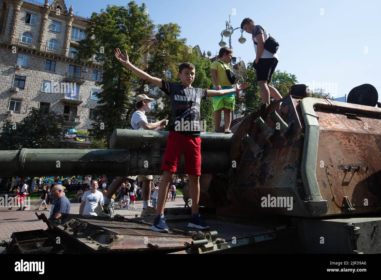 Children play on a destroyed Russian tank located on the main street Khreshchatyk as part of the upcoming celebration of the Independence Day of Ukraine amid Russia's invasion of Ukraine in central Kyiv. Stock Photo
