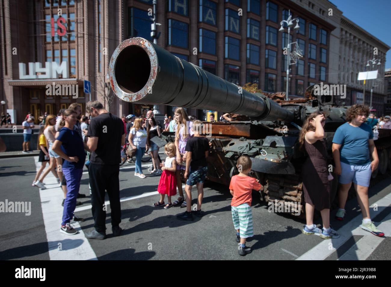 People look at the destroyed Russian tank displayed on the main street Khreshchatyk as part of the upcoming celebration of the Independence Day of Ukraine amid Russia's invasion of Ukraine in central Kyiv. Stock Photo