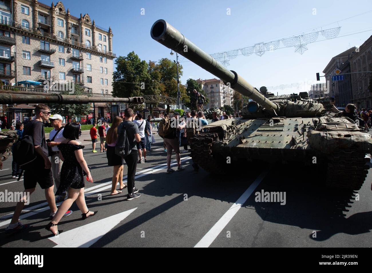 People walk past a destroyed Russian tank displayed on the main street Khreshchatyk as part of the upcoming celebration of the Independence Day of Ukraine amid Russia's invasion of Ukraine in central Kyiv. Stock Photo