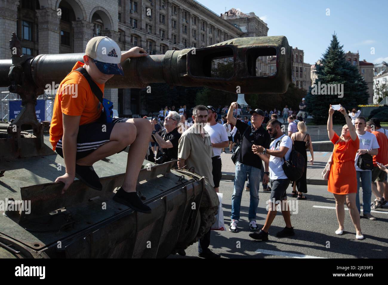 A boy plays on a destroyed Russian tank displayed on the main street Khreshchatyk as part of the upcoming celebration of the Independence Day of Ukraine amid Russia's invasion of Ukraine in central Kyiv. Stock Photo