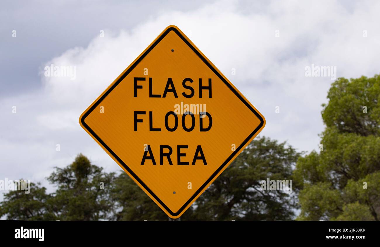 Sign identified FLASH FLOOD AREA danger and warning.  Location is Gordon Hirabayashi Recreation Area on Mount Lemmon along Catalina Highway in Tucson, Stock Photo