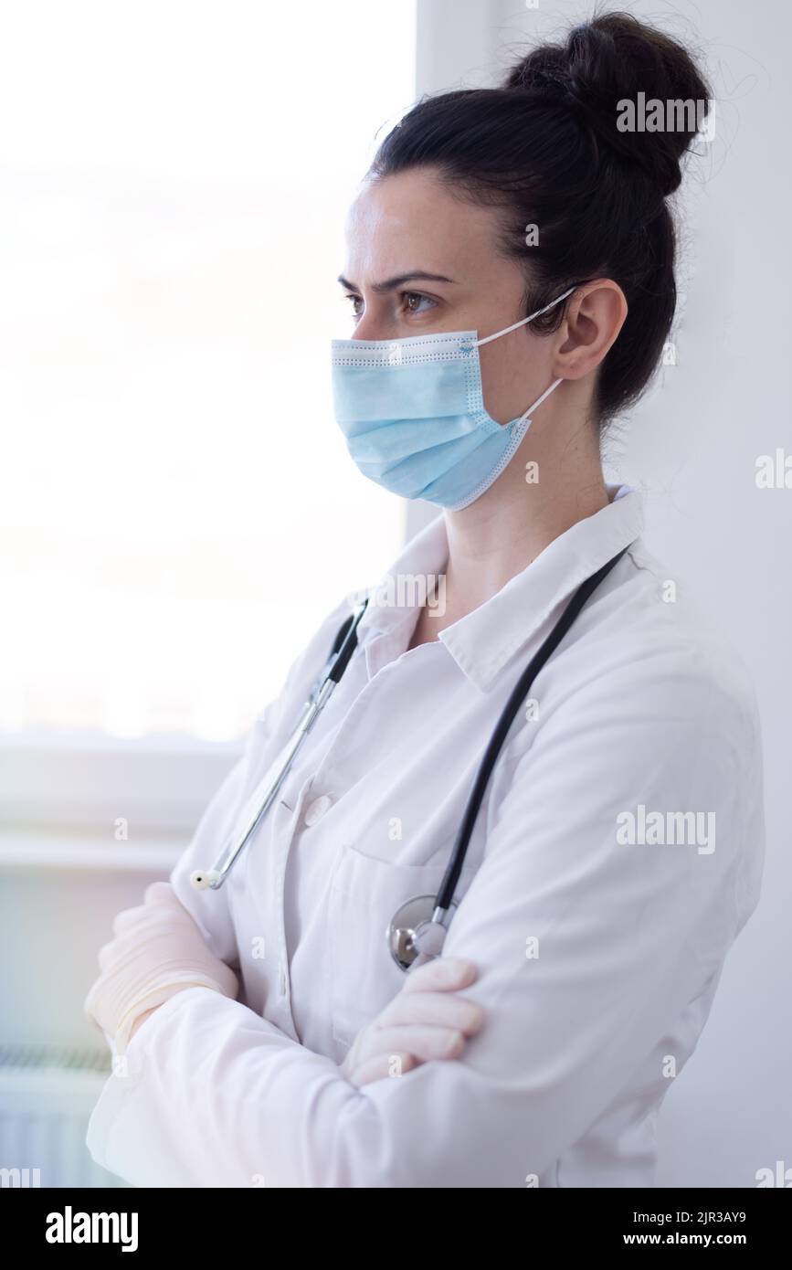 Confident female doctor posing in her office Stock Photo