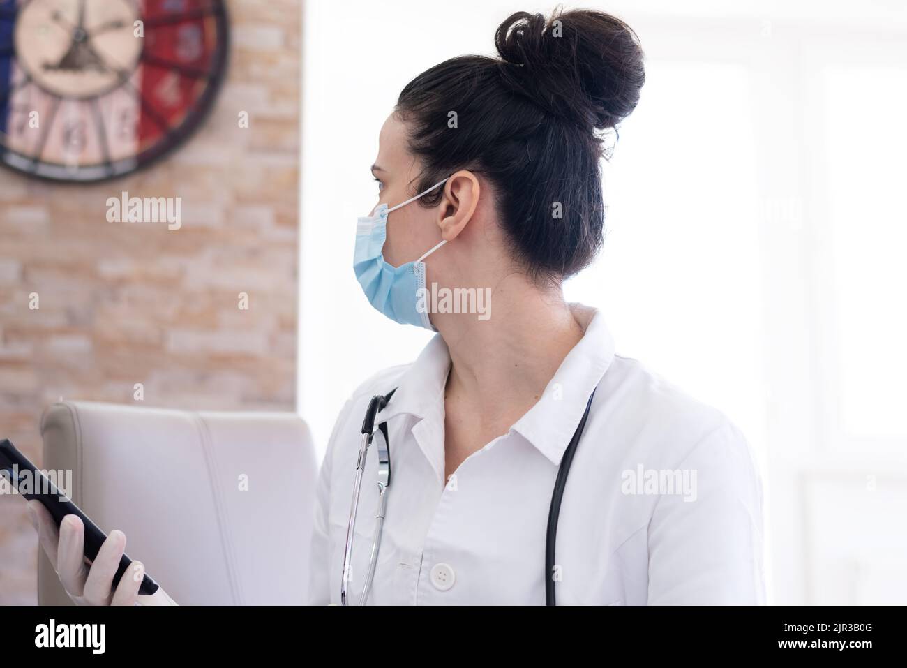 Confident female doctor posing in her office Stock Photo