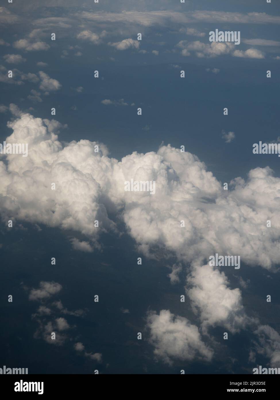 Big white puffy clouds from airplane window Stock Photo - Alamy