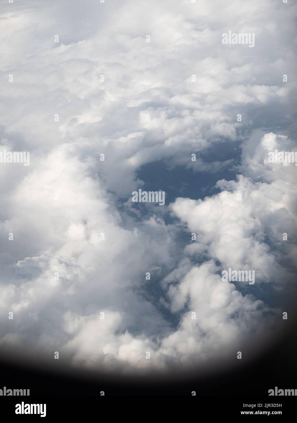 Big white puffy clouds from airplane window Stock Photo - Alamy