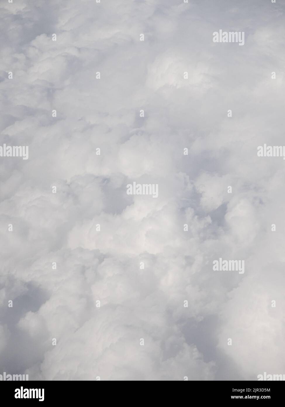 Big white puffy clouds from airplane window Stock Photo Alamy