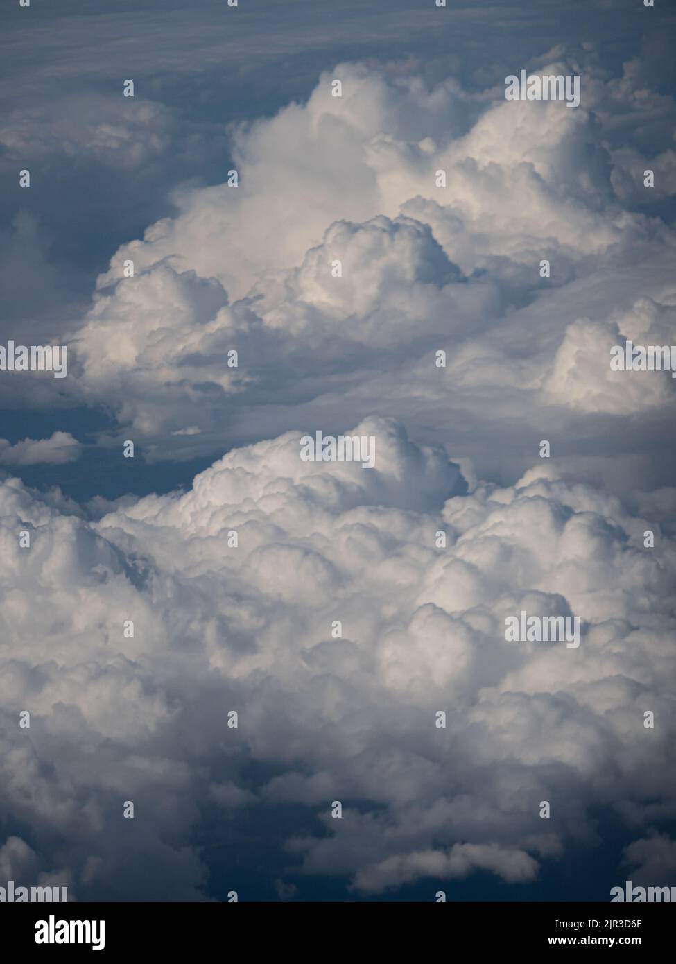 Big white puffy clouds from airplane window Stock Photo Alamy