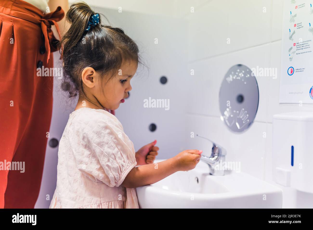 little girl washing her hands in the kindergarten. High quality photo Stock Photo
