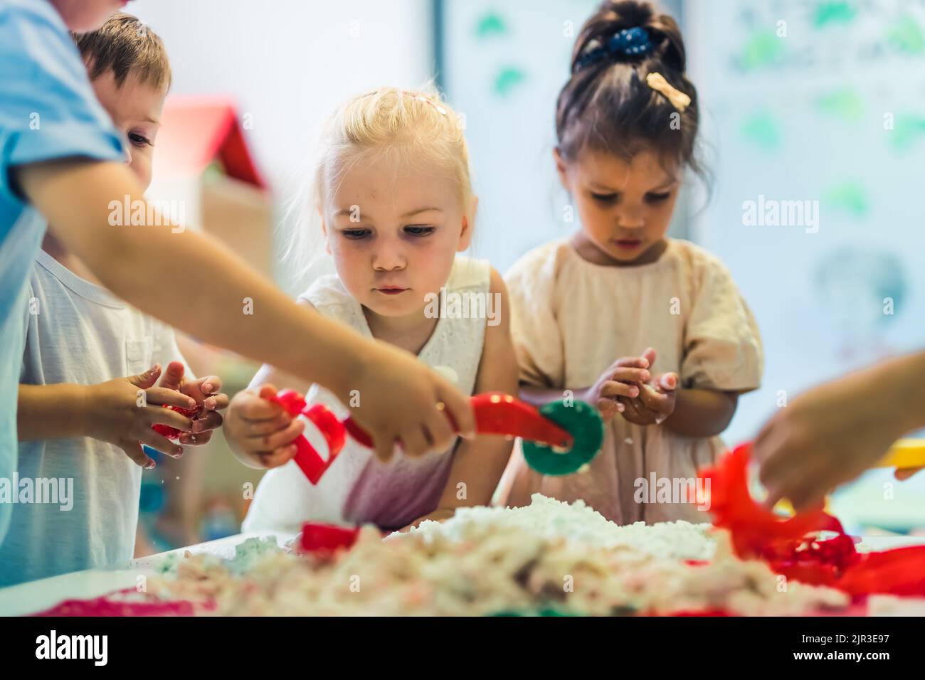 kids playing with kinetic sand at the nursery. High quality photo Stock Photo