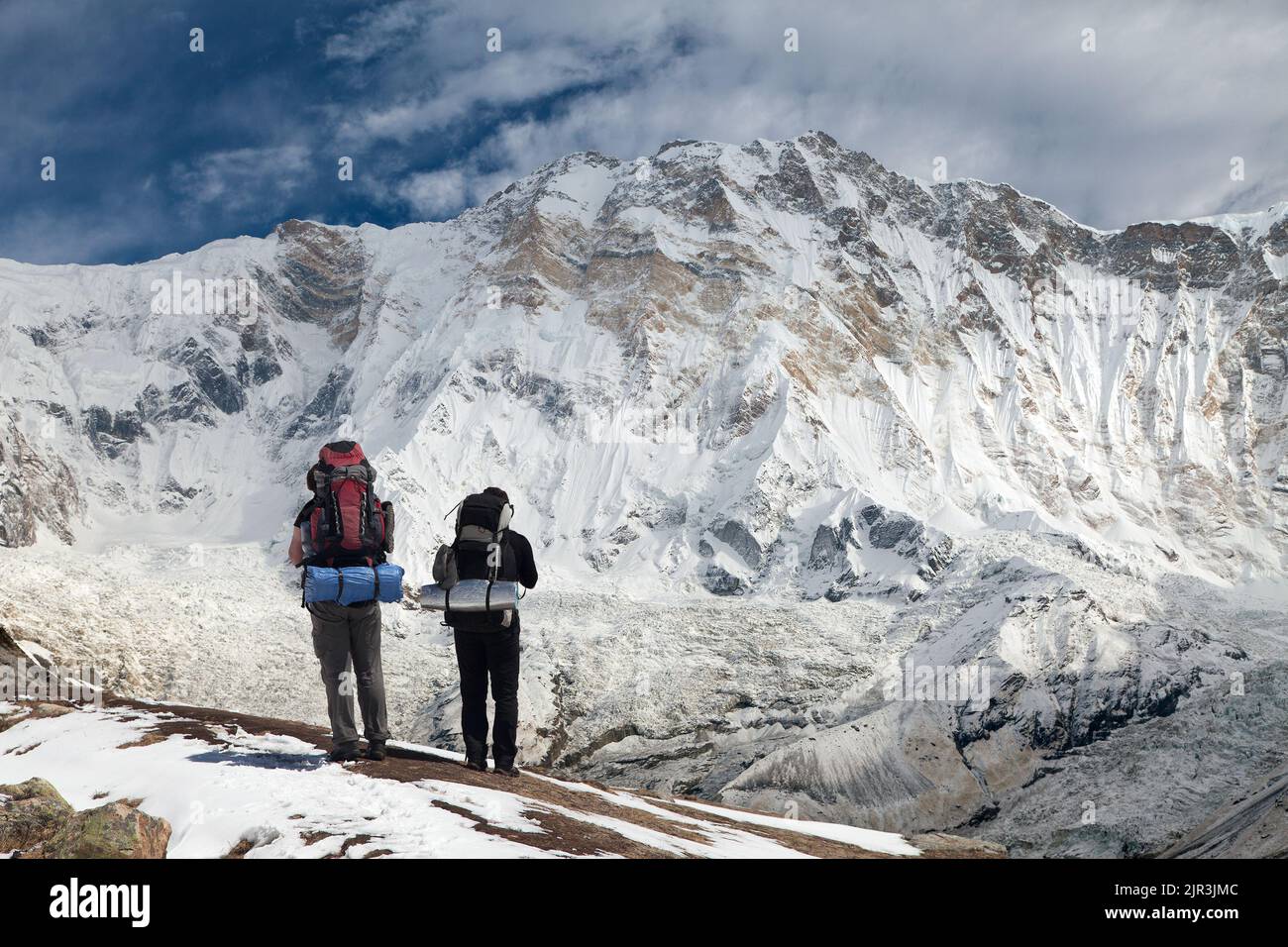View of Mount Annapurna with two climbers, round Annapurna circuit ...