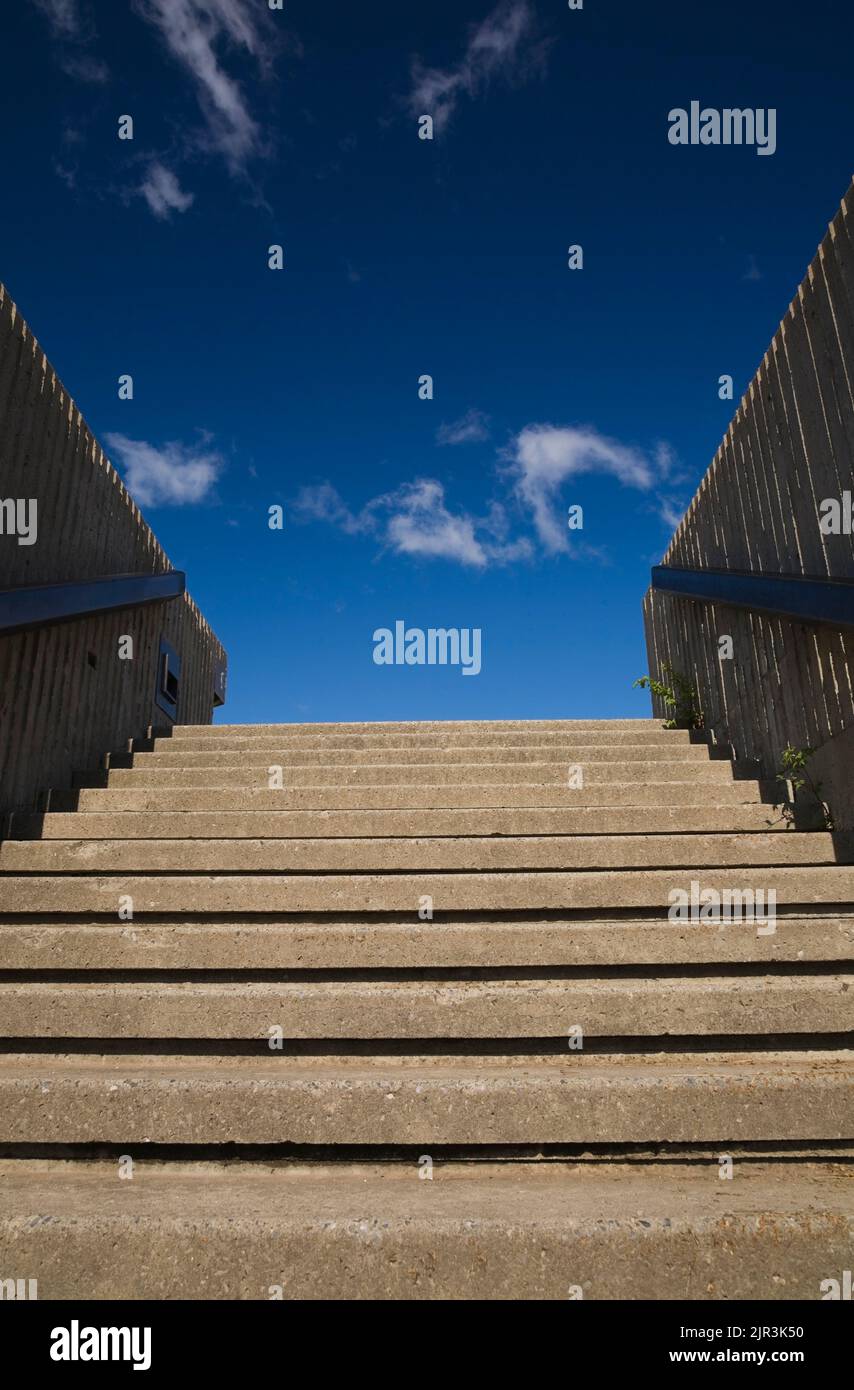 Cement steps leading up to blue sky and clouds. Stock Photo