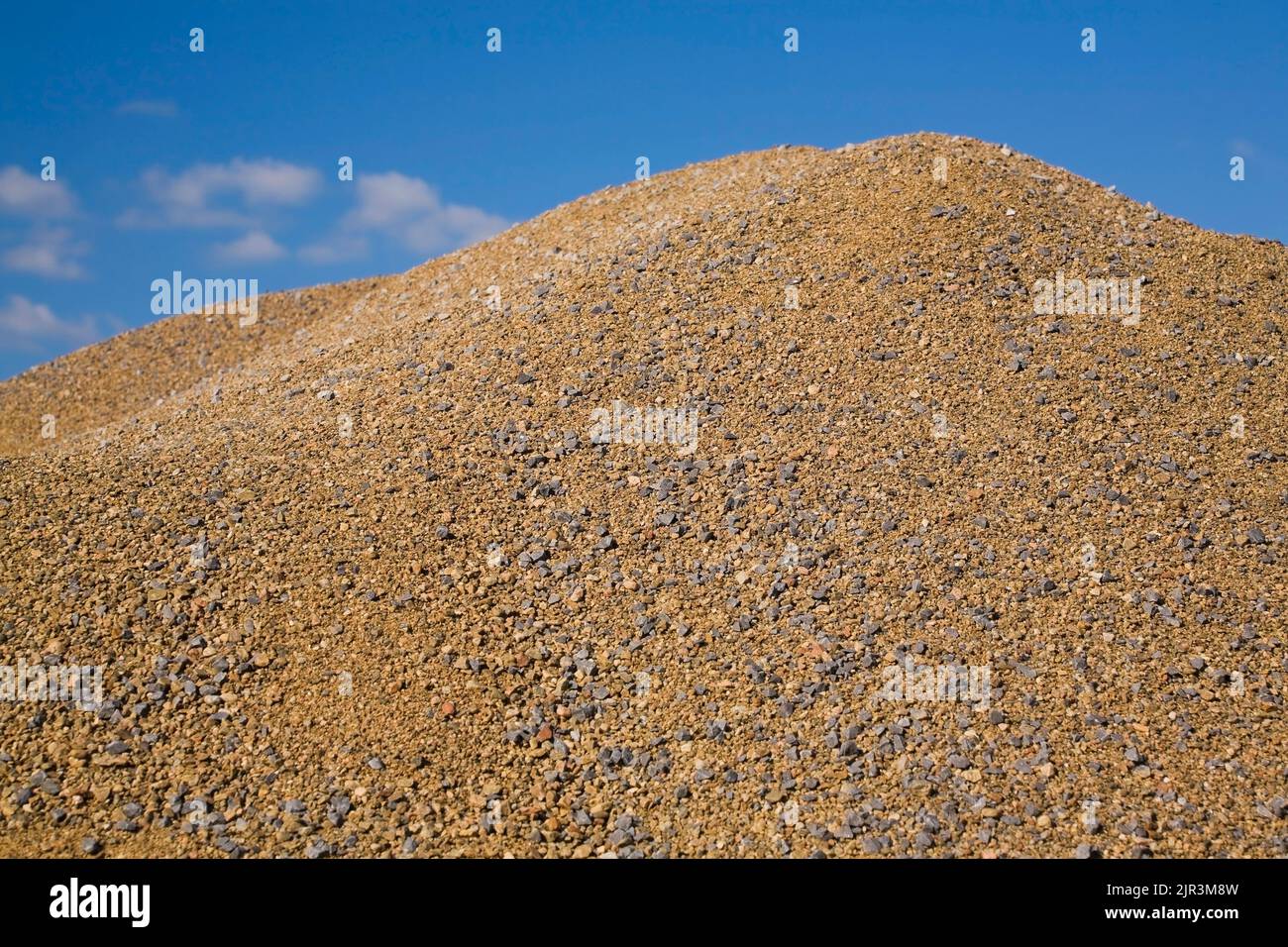Mound of coarse sand and pebbles in a commercial sandpit. Stock Photo