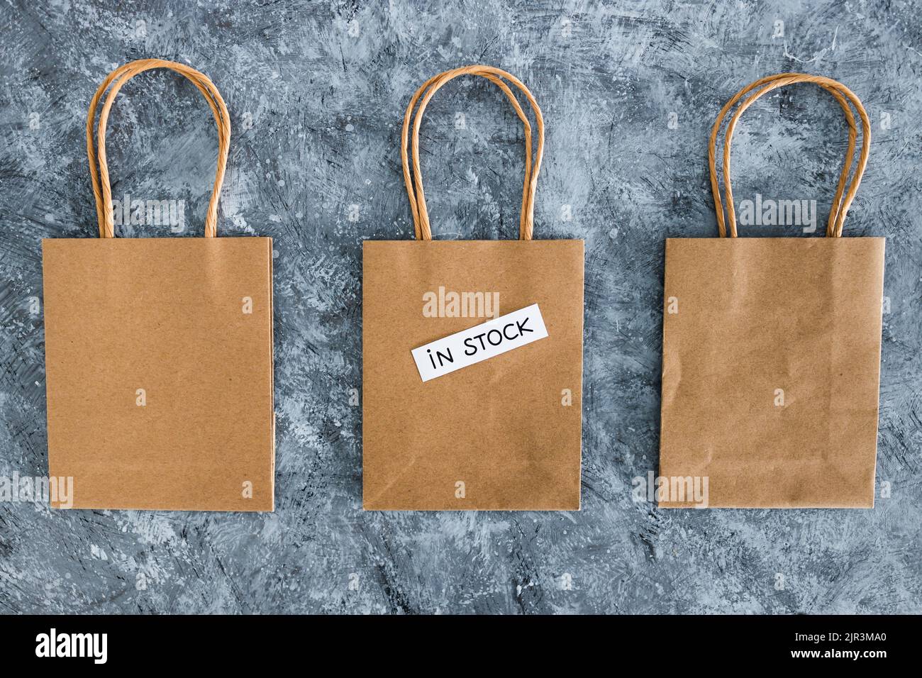 In Stock Text In stock text on top of shopping bags, concept of shopping and retail ...