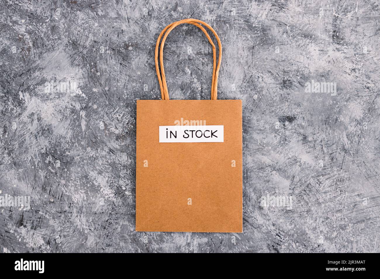 In Stock Text In stock text on top of shopping bags, concept of shopping and retail ...