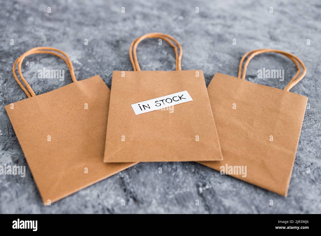 In Stock Text In stock text on top of shopping bags, concept of shopping and retail ...