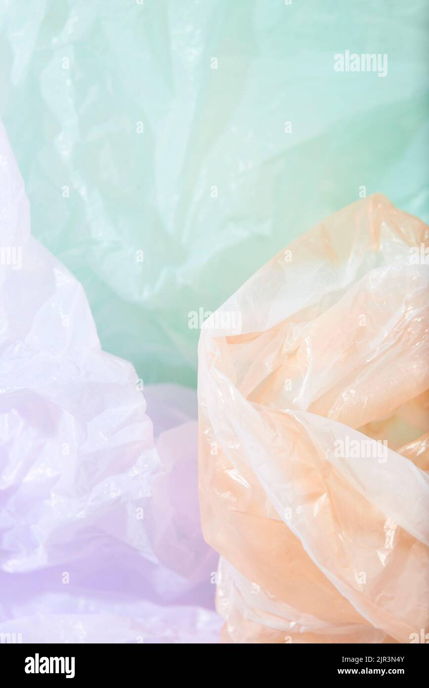 Purple, orange and green background, single use plastic bags. Concepts