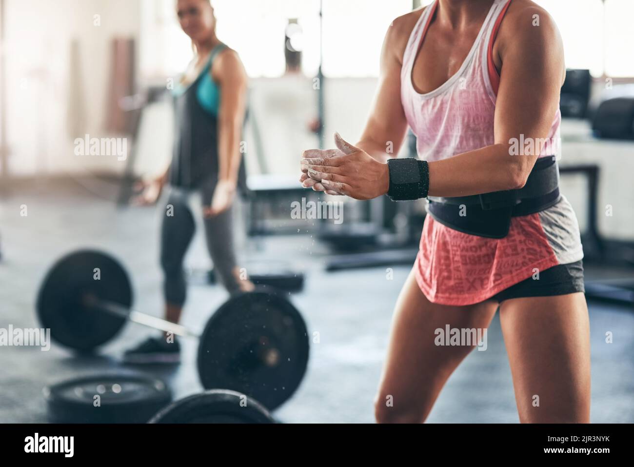 Bring it on. an unidentifiable woman rubbing chalk powder on her hands