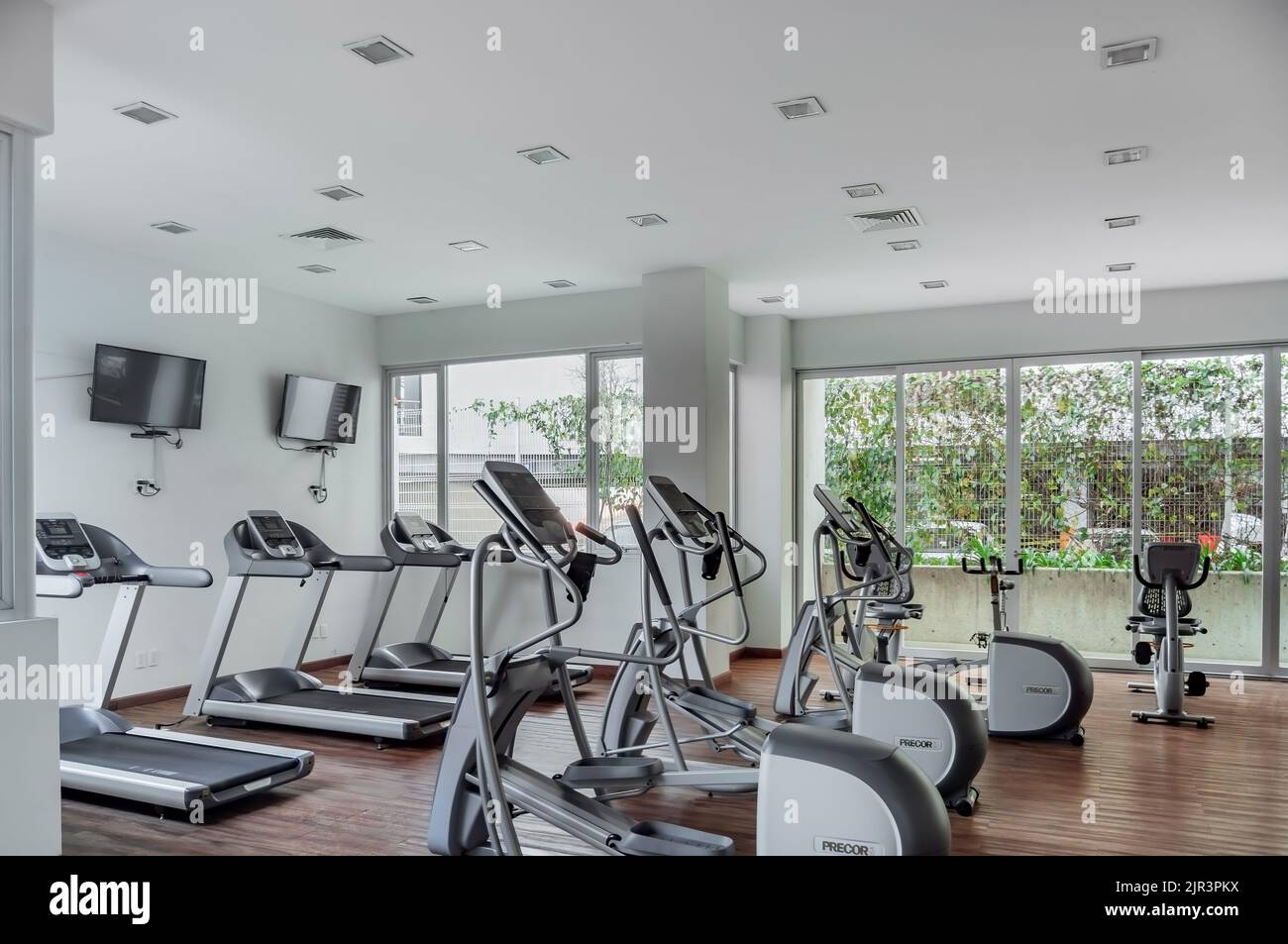 gym as an amenity within apartment towers, treadmill with televisions