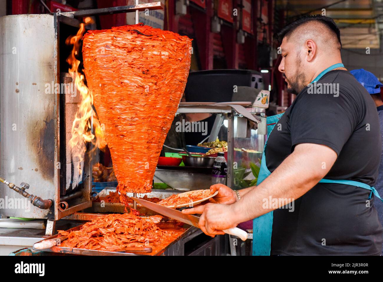 Food vendor preparing Al pastor meat at Lucas de Galvez market, Merida