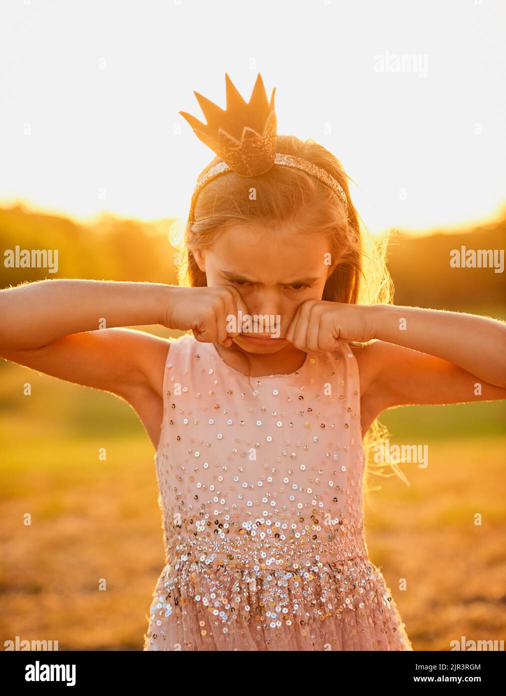 No, playtime cant be over yet. an adorable little girl playing outdoors. Stock Photo