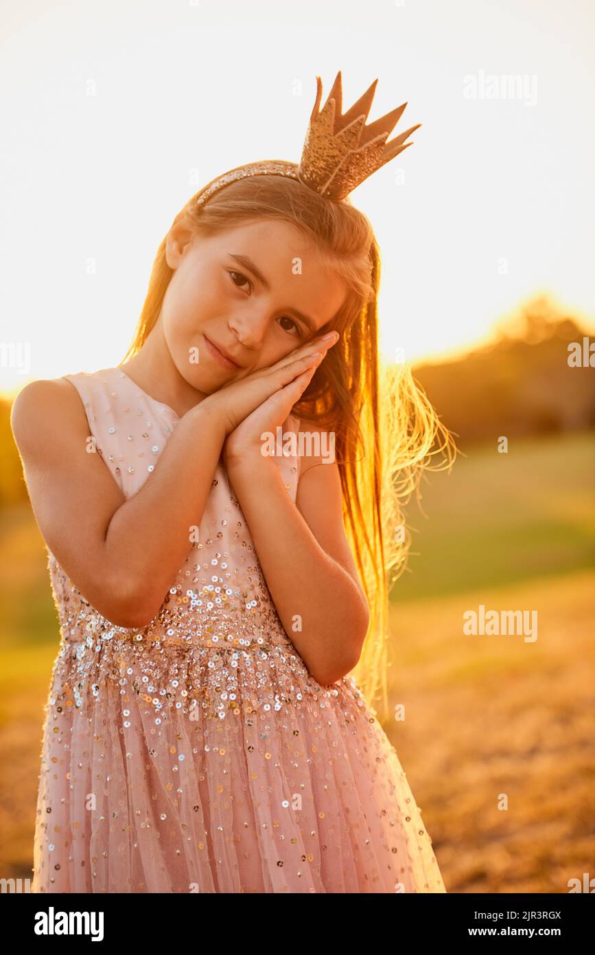 After a day of playing, someone wants to take a nap. an adorable little girl playing outdoors. Stock Photo