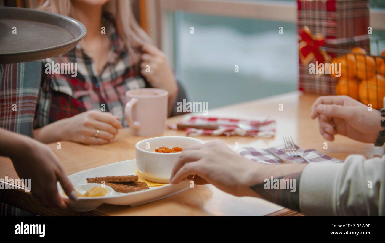 A couple in cafe having a lunch and about to eat the porridge Stock Photo