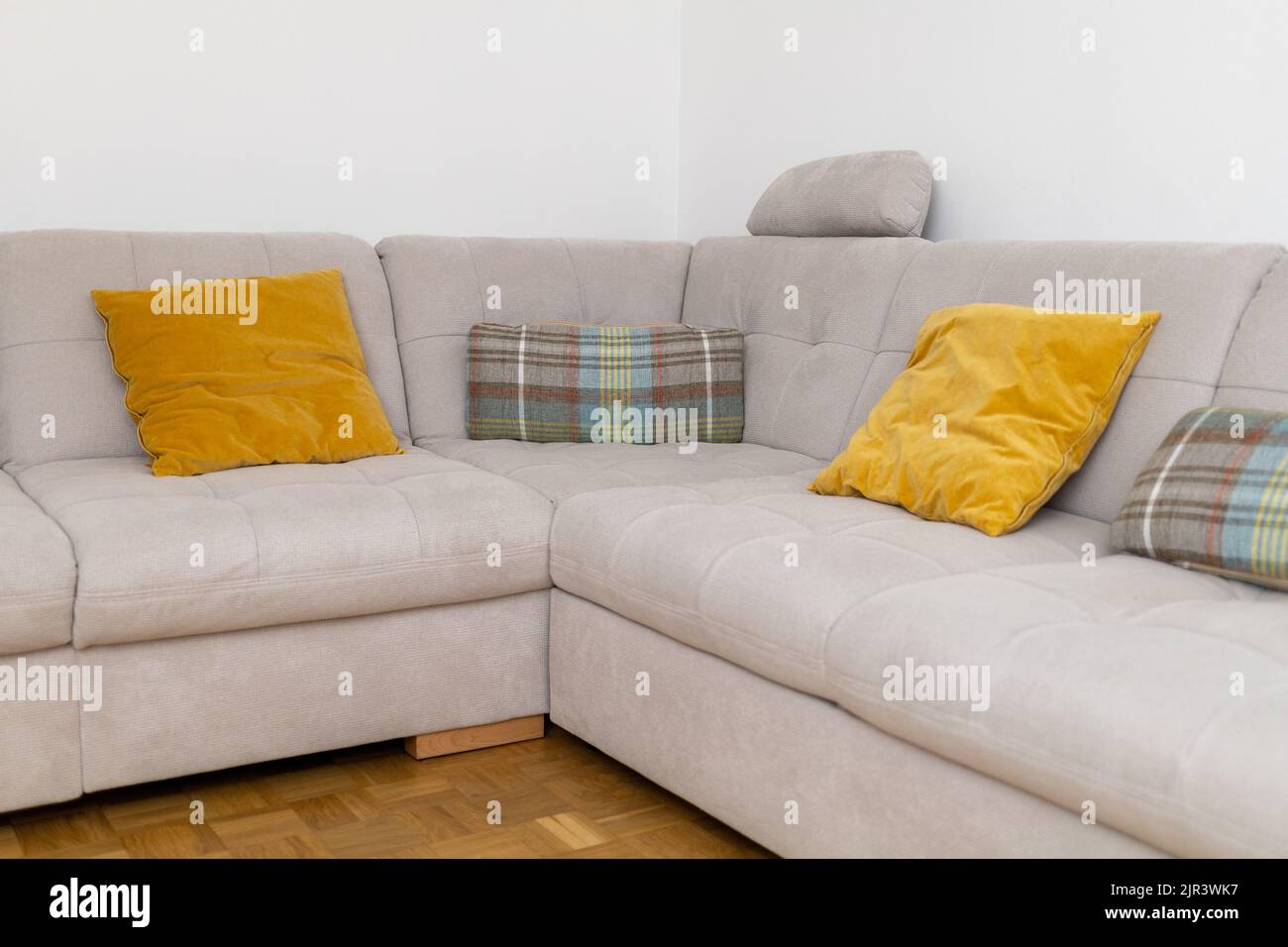 interior corner soft sofa with yellow pillows Stock Photo