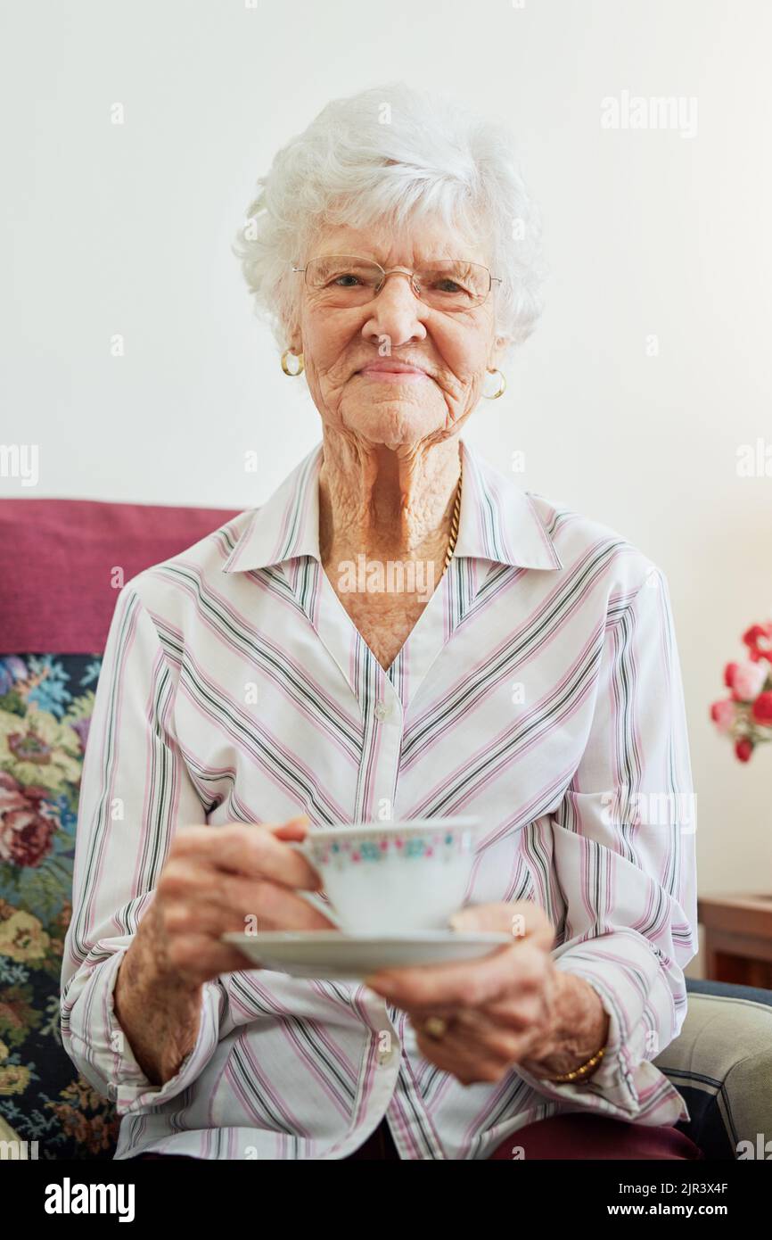 Anyone care to join me for some tea. Portrait of s senior woman having a cup of tea. Stock Photo