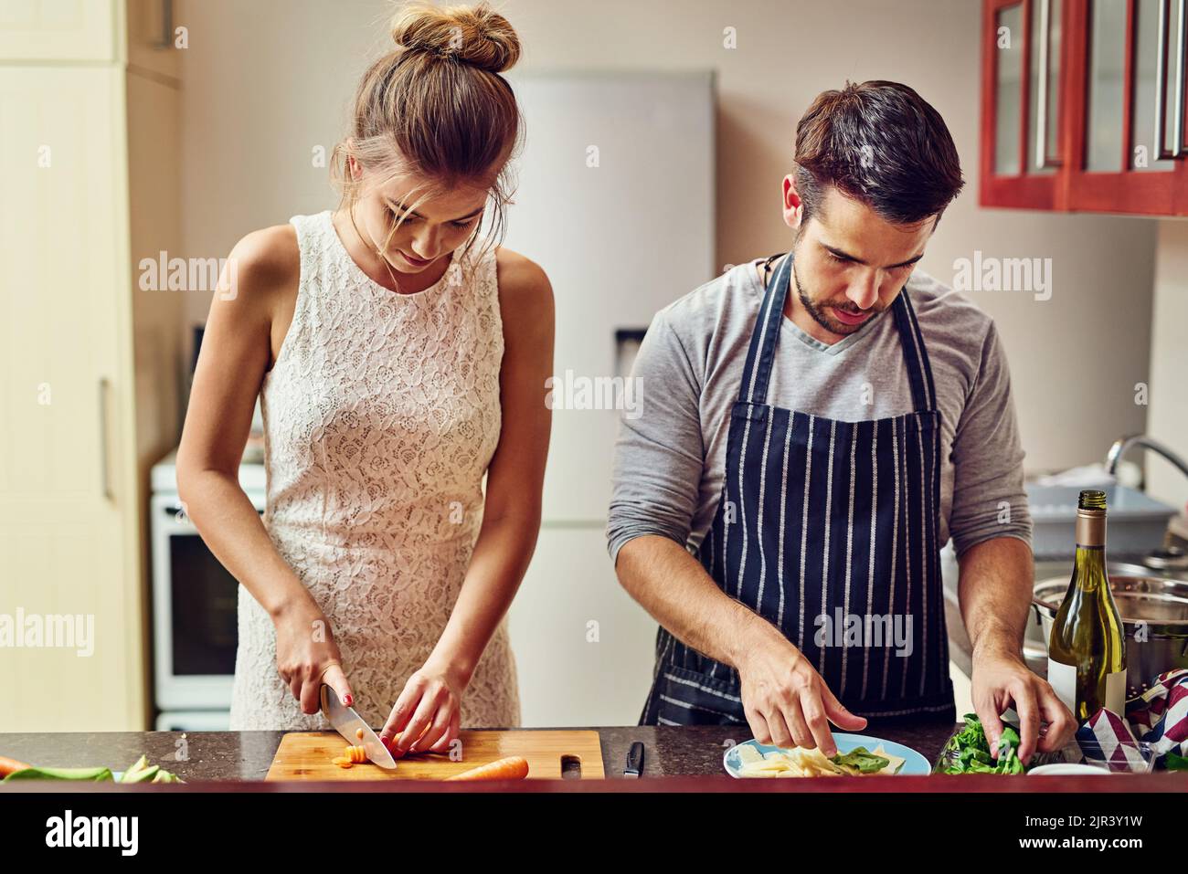 Cooking with love provides food for the soul. a young couple preparing food together at home. Stock Photo