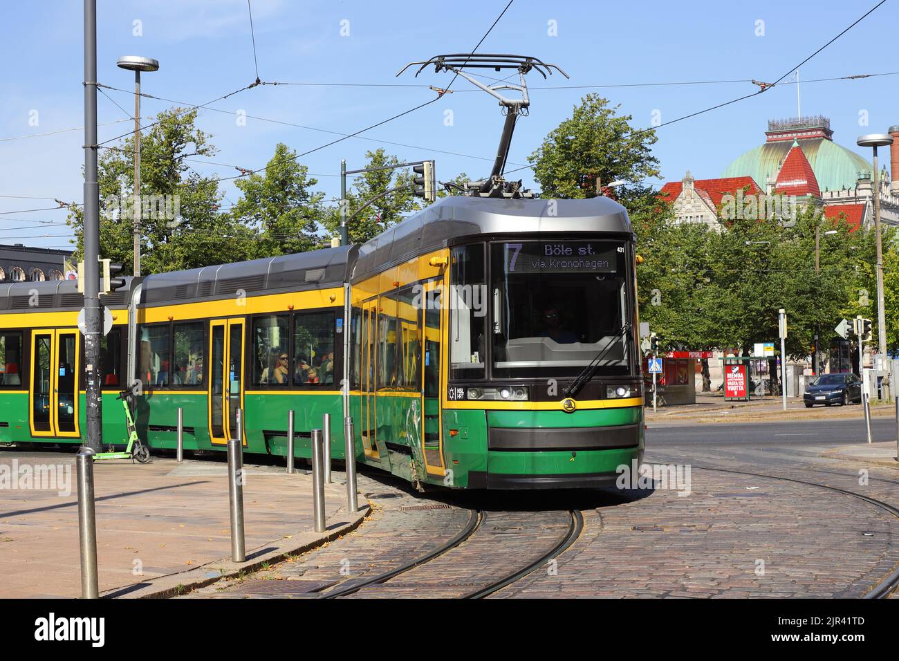 Helsinki, Finland - August 20, 2022: Articulated low-floor class MLNRV III Artic modern tram in service on line 7 at the Central railroad station area Stock Photo