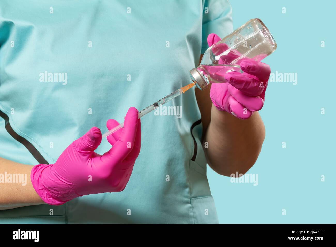 Plastic syringe and bottle for liquid medicine in hands Stock Photo Alamy