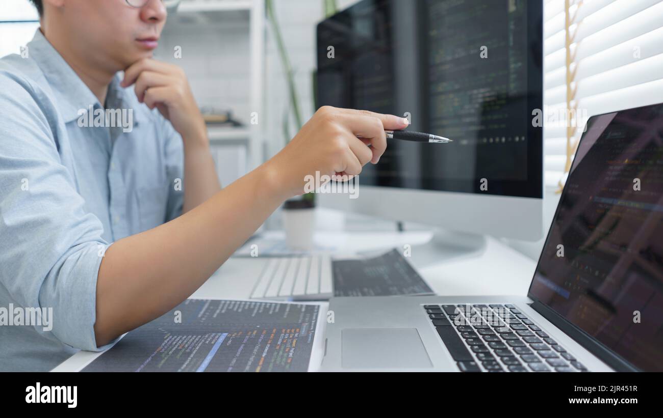 Software development concept, Male programmer pointing on laptop screen ...